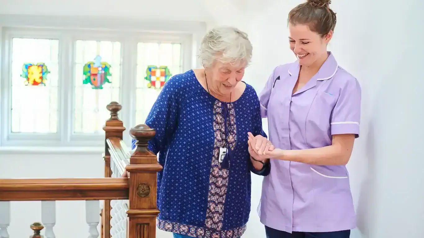 carer helping elderly female on stairs
