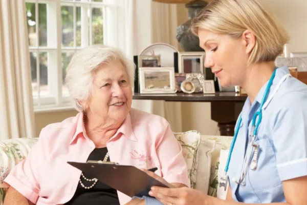 Support at Home assessor discussing aged care needs with a senior woman during an in-home visit.